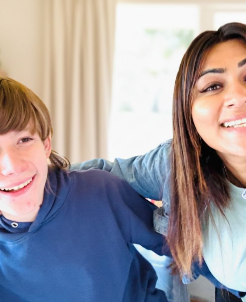 Child in wheelchair interacting with caregiver